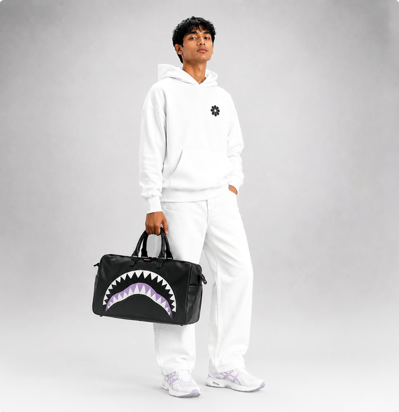 Model carrying a printed duffel bag
